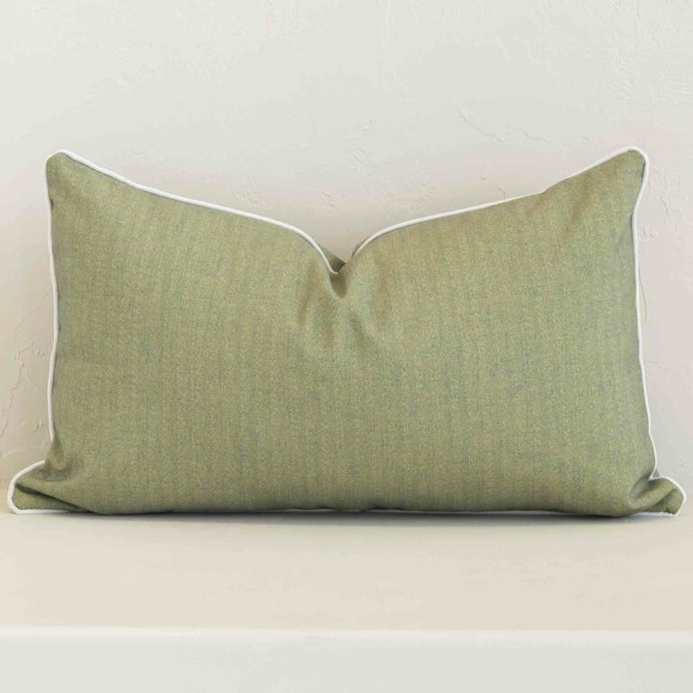 A bold solid-coloured outdoor cushion in a sleek rectangle size with a sage tone of colour.