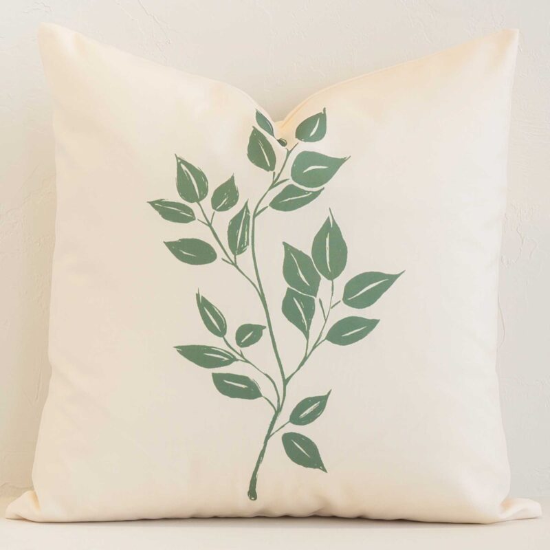 A hero shot of a solid-colour square cushion cover. It is made from a deluxe outdoor fabric and features a cream colour.