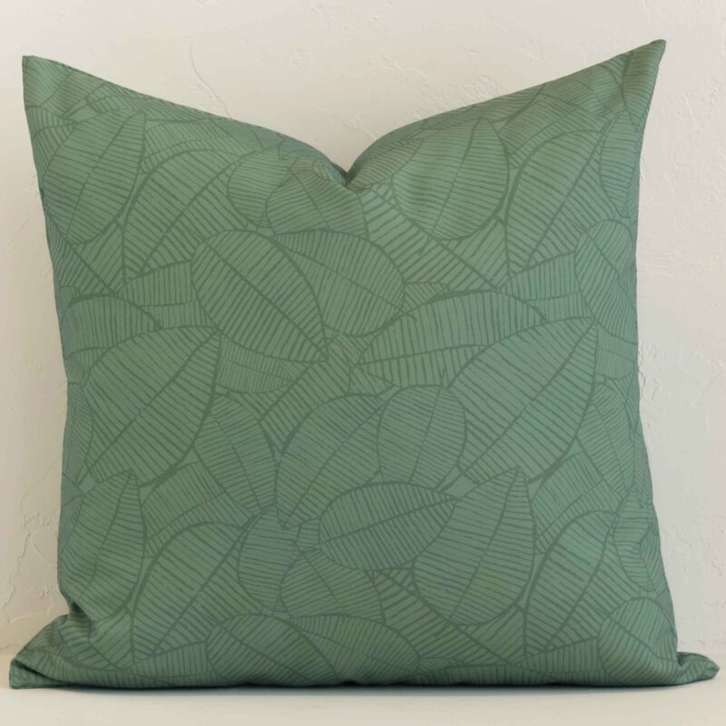 Sagewood Waterproof Palm Green Outdoor Cushion Cover - Large - SC1055-55 A lovely large green cushion cover arranged in front of a white wall. The floral style complements the outdoor material.