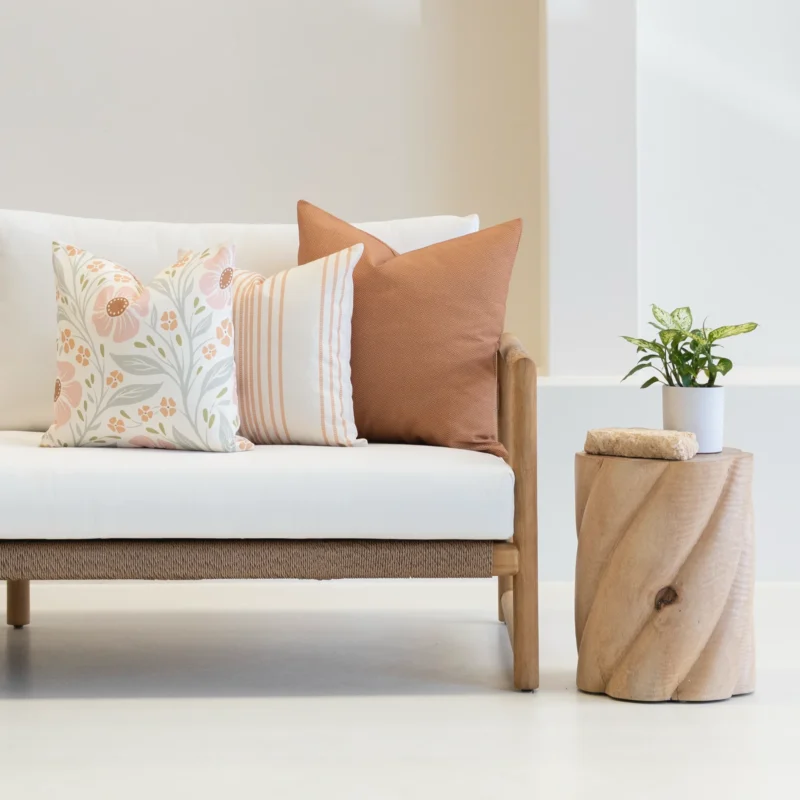 Outdoor seating with a set of 3 desert bloom outdoor couch cushions on it.
