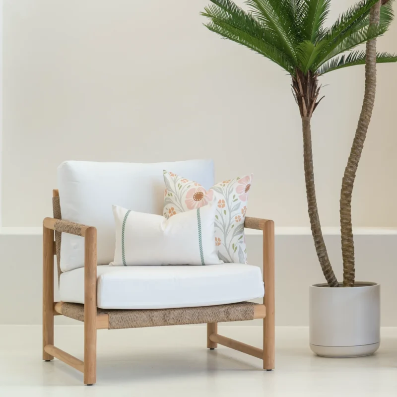 A set of 2 desert bloom outdoor cushions displayed on a single-seater chair.