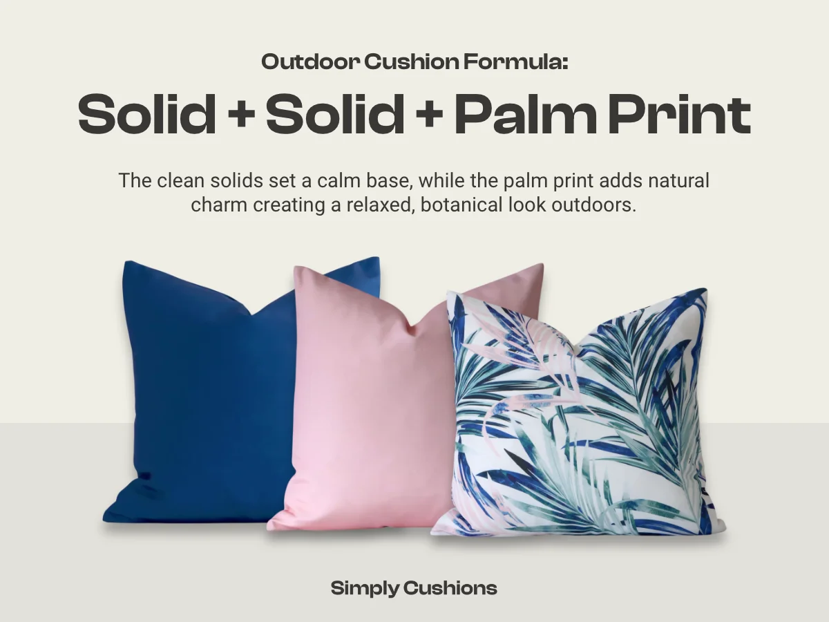 Outdoor cushion combination formula: solid + solid + palm print. A blue and pink solid is shown here in the example along with a multi coloured palm print. The clean solids set a calm base, while the palm print adds natural charm creating a relaxed, botanical look outdoors.