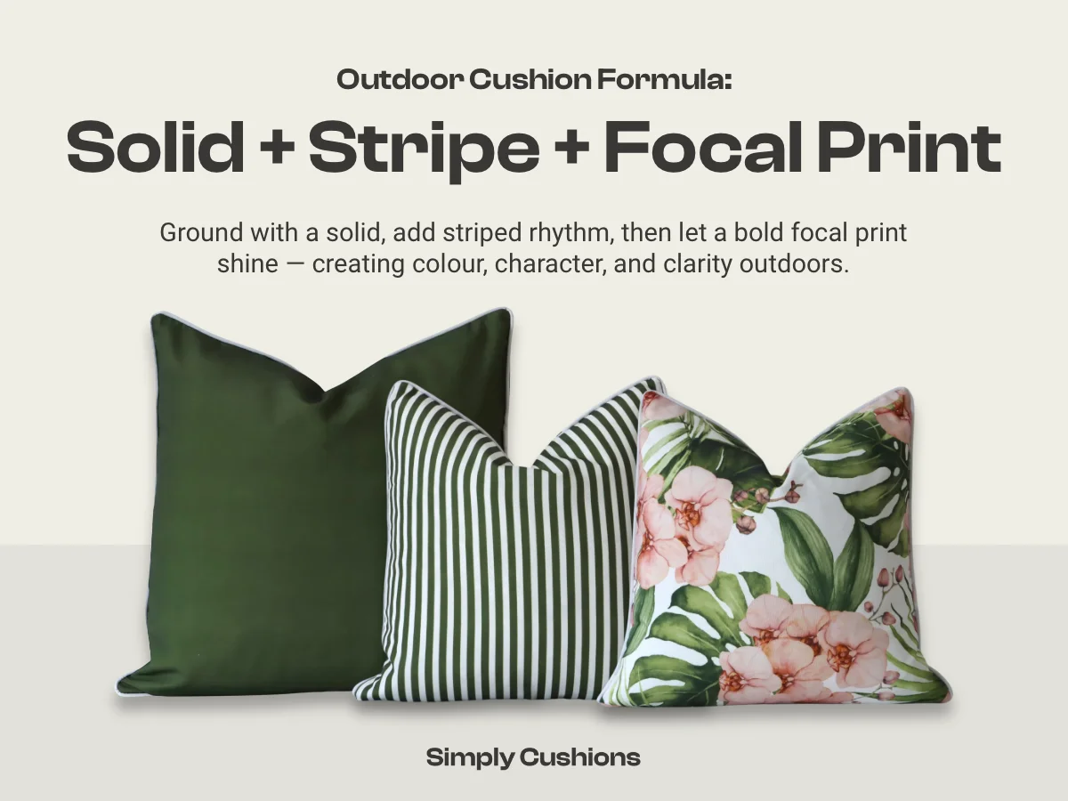 Outdoor cushion combination formula: solid + stripe + focal print. Green outdoor cushions are shown in the example, one with a colourful pink and green floral print. Ground with a solid, add striped rhythm, then let a bold focal print shine — creating colour, character, and clarity outdoors.