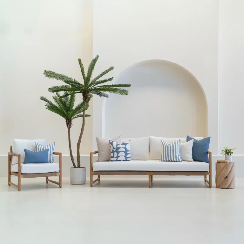 Set of 7 pacific cove outdoor sofa cushions is arranged neatly on a white sofa.