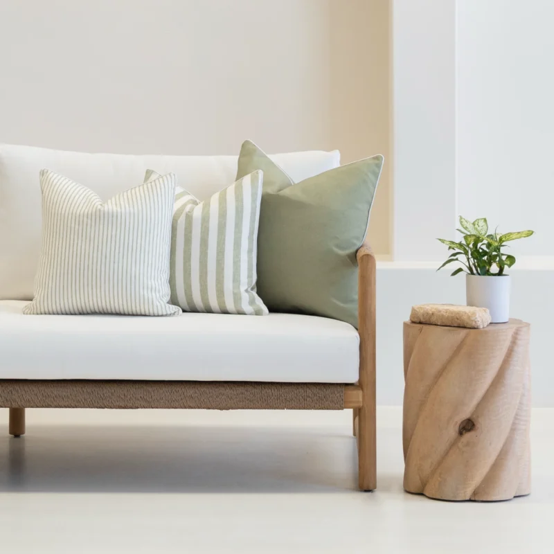 Pacific sage set of 3 sofa cushions is styled on a white couch.