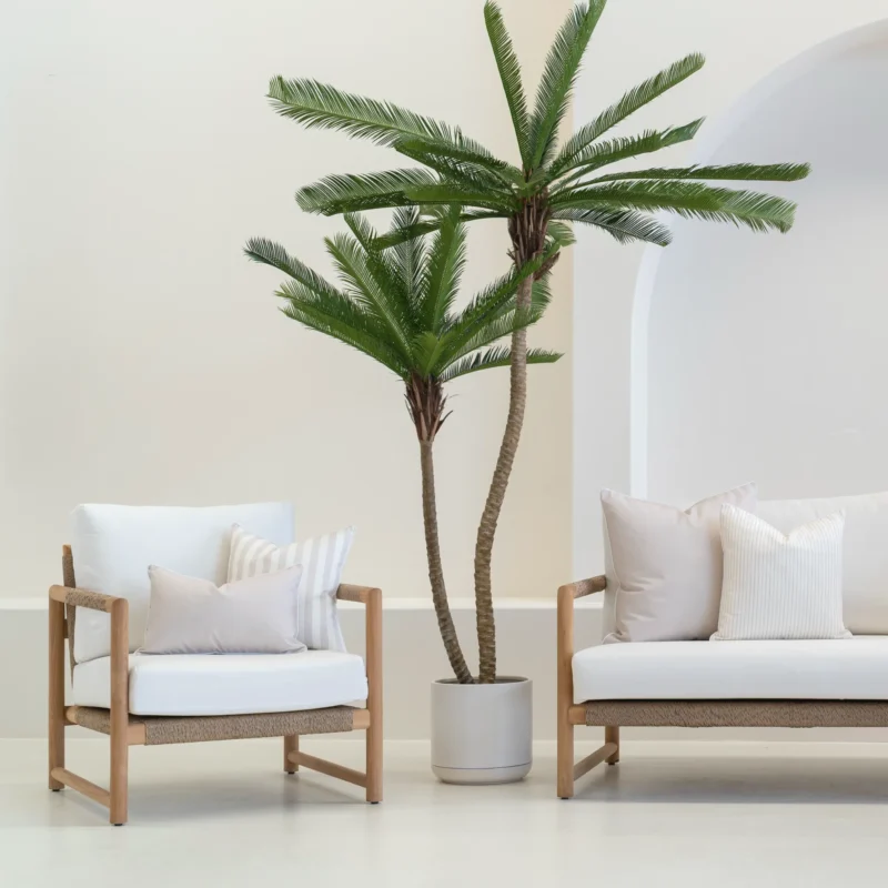 Outdoor seating with a white sofa displaying 4 pacific sand outdoor cushions.