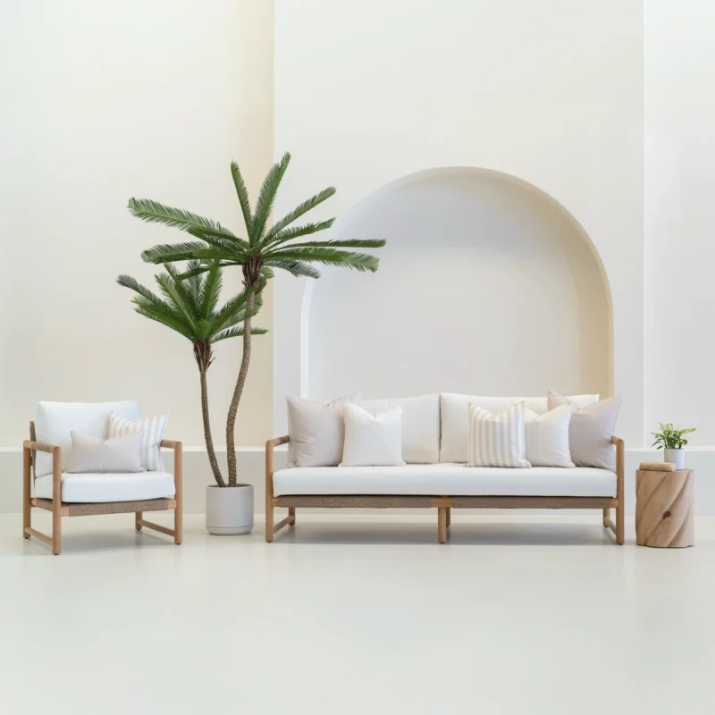 Outdoor seating with white sofa displaying a set of 7 pacific sand outdoor sofa cushions on it.