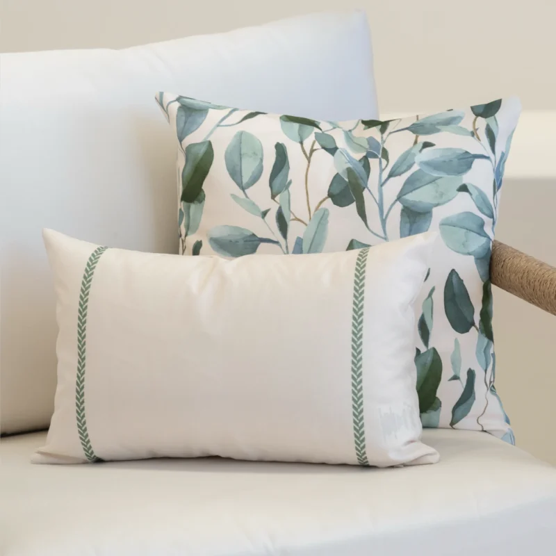 A white sofa styled with a set of 2 sagewood outdoor cushions.