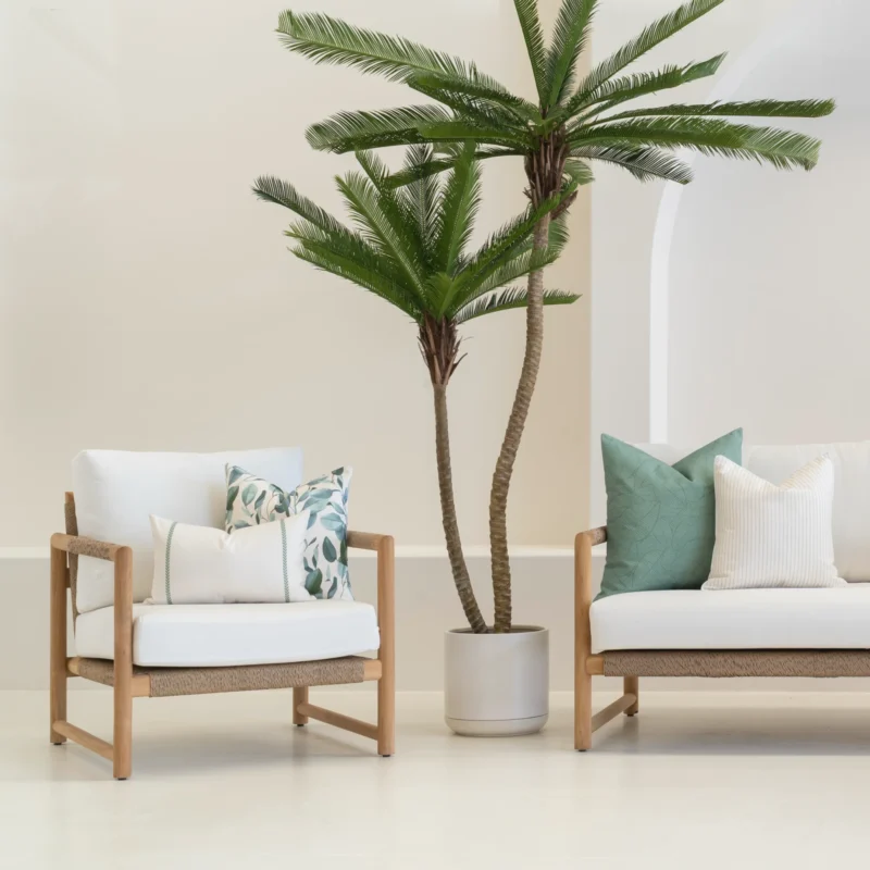 White sofa in an outdoor living room showing 4 outdoor cushions in a sagewood colour.