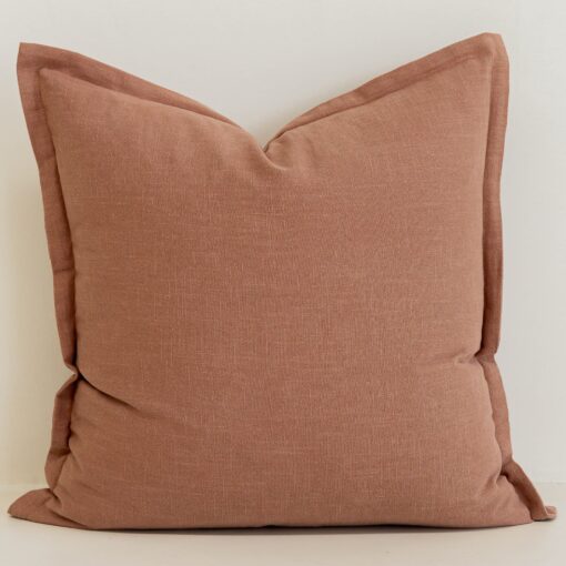 Close-up of Clay linen cushion in warm terracotta tone with soft texture.