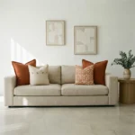 Marenca burnt orange cushions styled on beige sofa with patterned accent cushions.