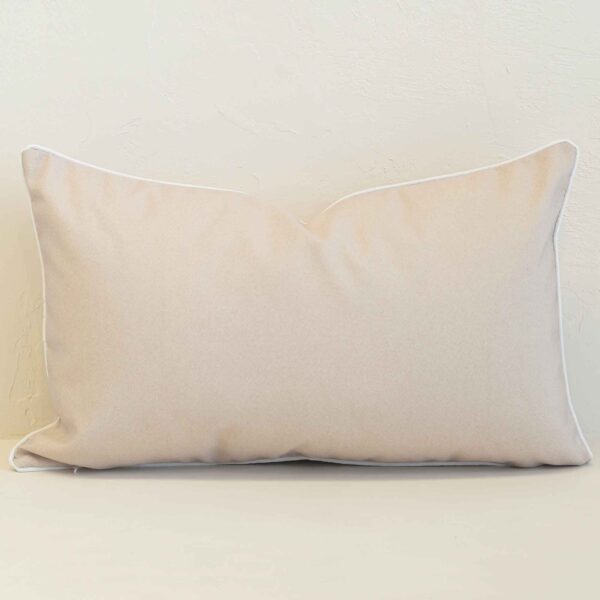 Pacific sand rectangular cushion with plain design and white piping edges.