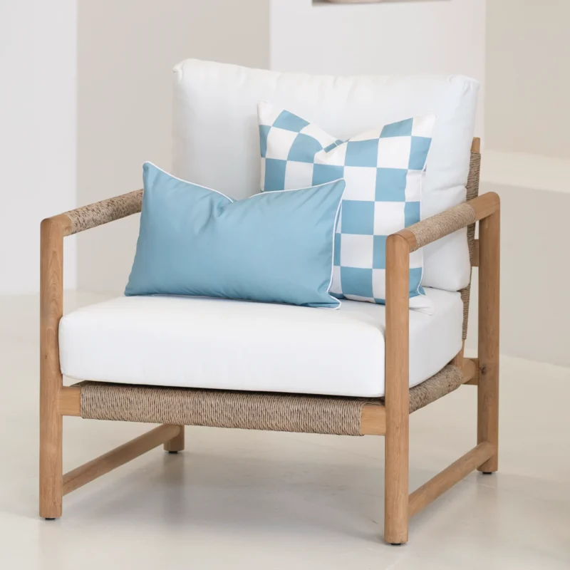 Tropica aqua cushions on armchair with check pattern and solid blue cushion.