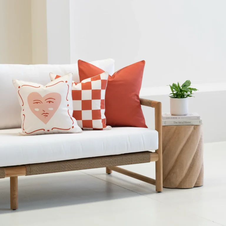 Tropica red cushions styled on sofa with check pattern and solid red cushions.