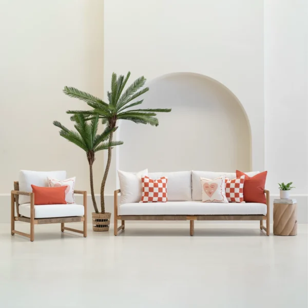 Tropica outdoor cushions in red and white patterns on sofa and chair.