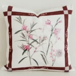 Cream cushion cover with mulberry check border and pink florals.