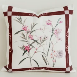 Cream cushion cover with mulberry check border and pink florals.