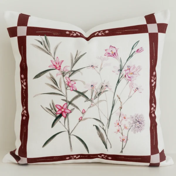 Cream cushion cover with mulberry check border and pink florals.