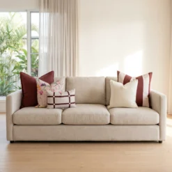 Five-piece cushion set with burgundy linen and mulberry stripe blocks, cream and floral prints, and a checked lumbar, on a sofa.
