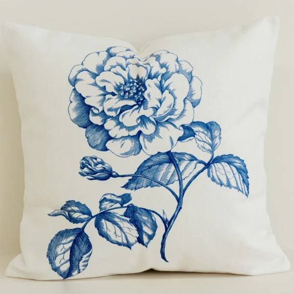 Cream cushion cover with large blue hand-drawn rose print.