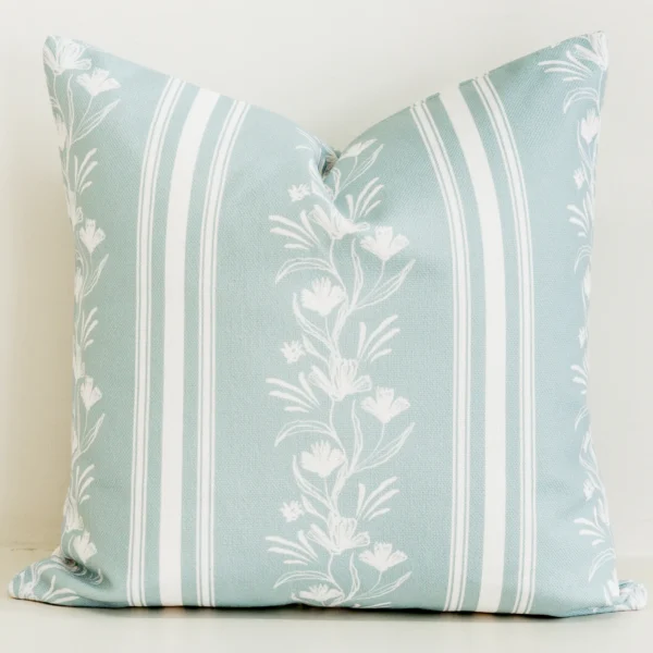 Sage green striped cushion cover with white floral vine detail.