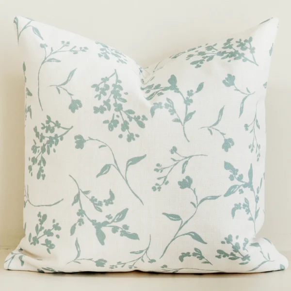 Sage green botanical sprig cushion cover on cream cotton-linen.