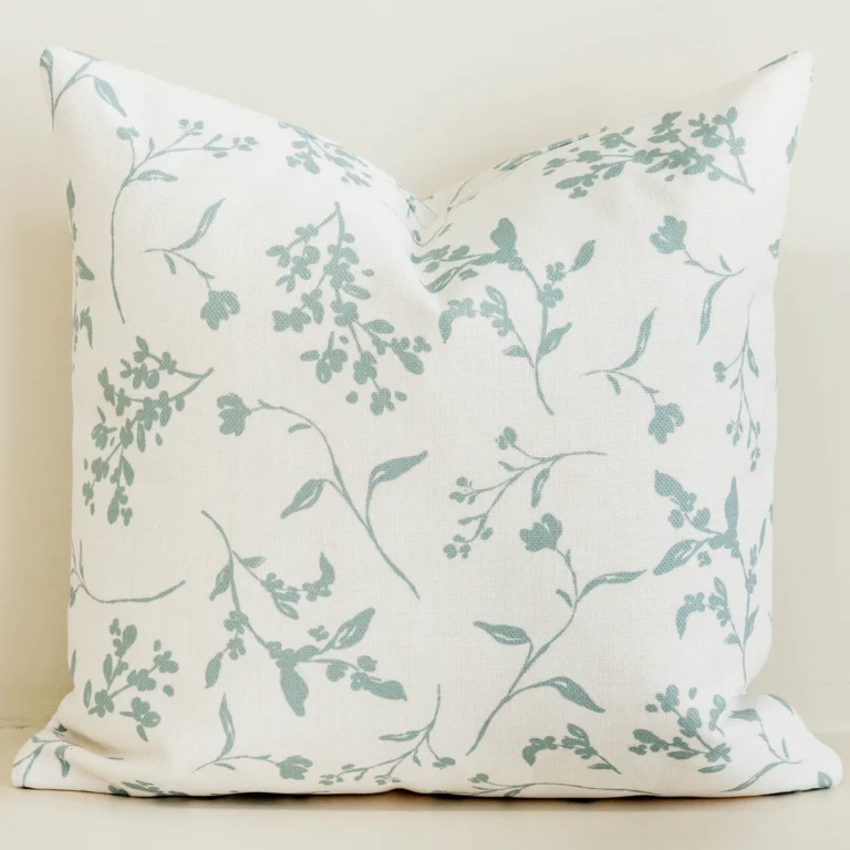 Sage green botanical sprig cushion cover on cream cotton-linen.