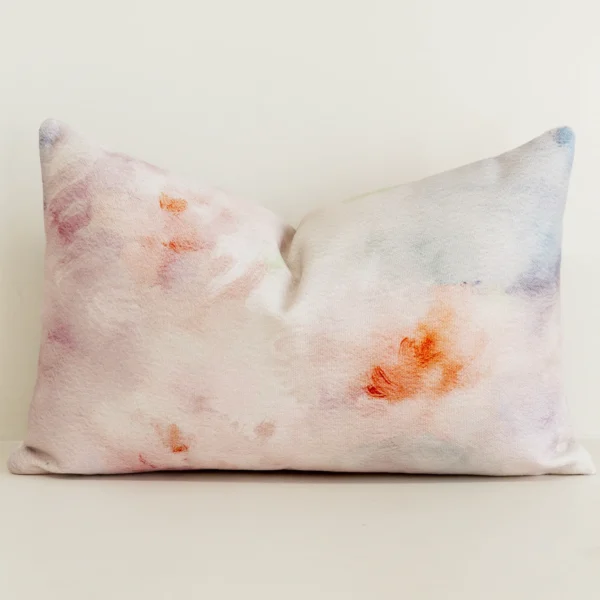 Pastel watercolour floral cushion cover in pink and coral tones.